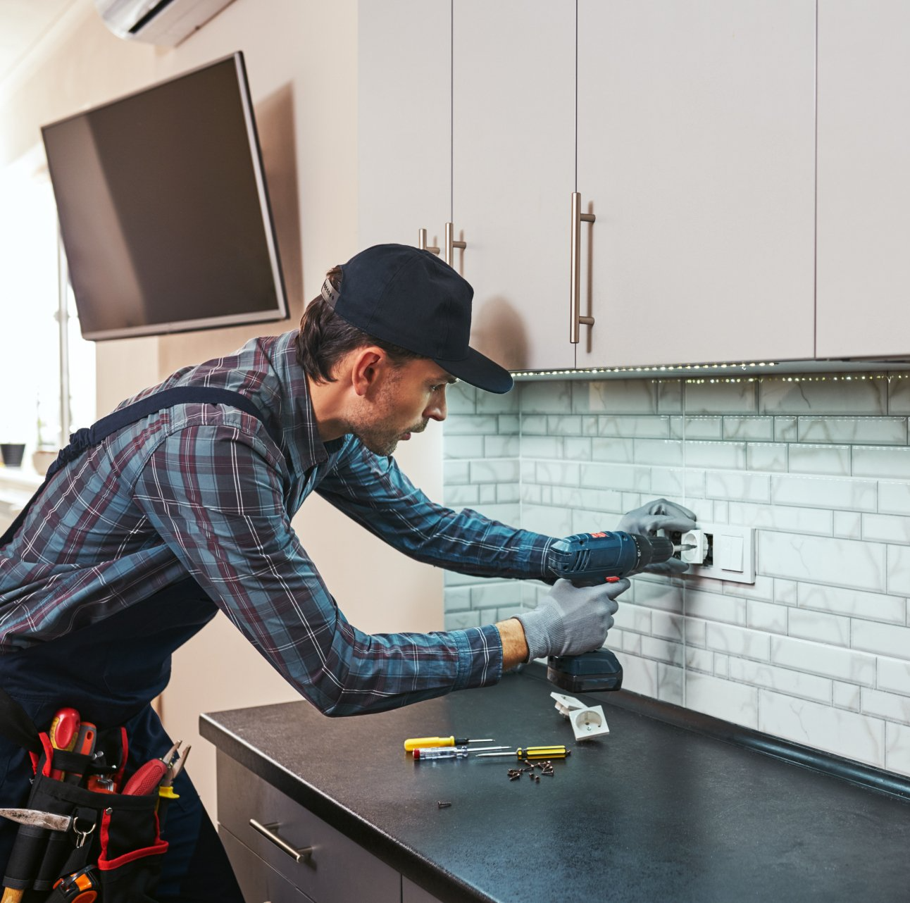an electrician adding protecting on an electrical outlet