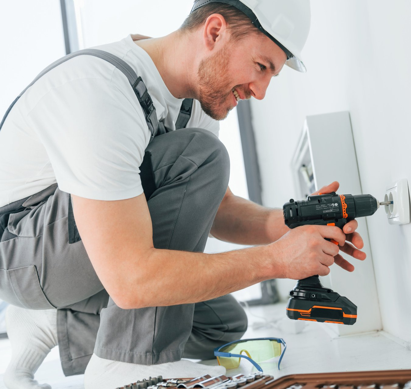 side view of an electrician making electrical repairs