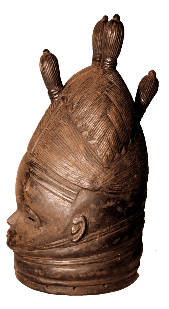 A dark, carved wooden head sculpture with intricate braided hair, tiered neck rings, and three vertical top extensions.