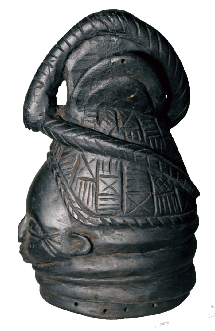 A dark, carved wooden Mende Sowei helmet mask with detailed geometric patterns, a high coiled hairstyle, and neck rings.