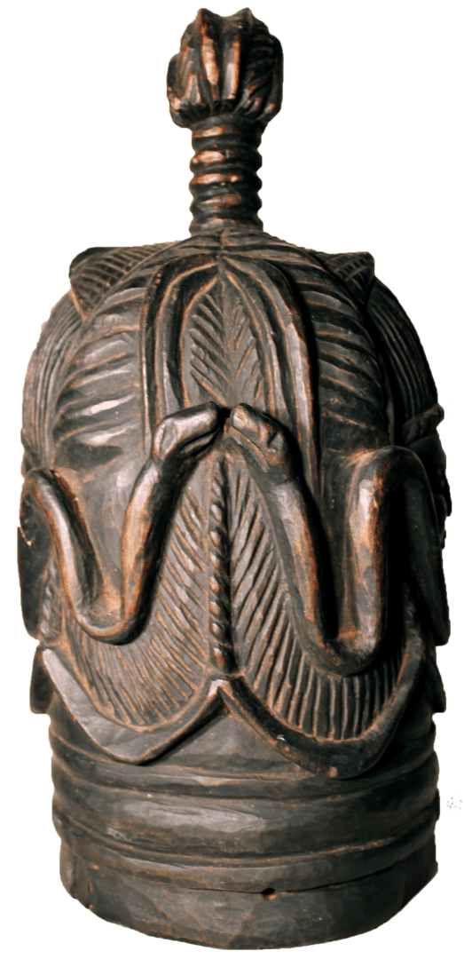 A dark, hand-carved wooden finial with stylized leaf patterns, serpentine motifs, and a ribbed stem on a cylindrical base.