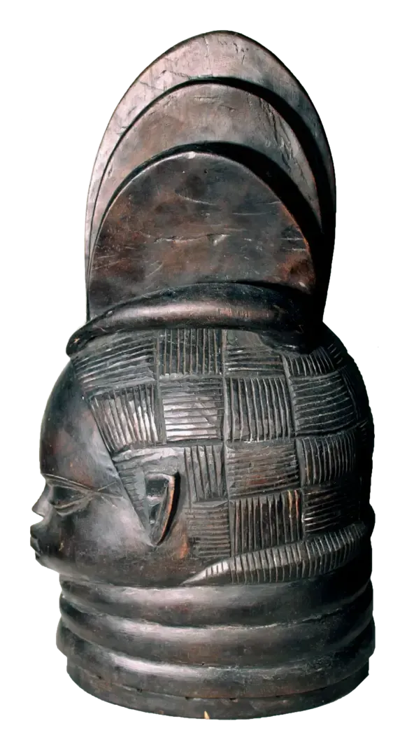 A dark, carved wooden helmet mask featuring an intricate checkerboard hairstyle and horizontal neck rings.