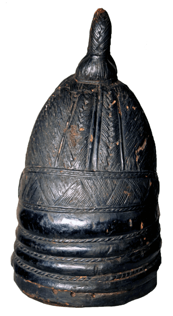 A dark, carved wooden vessel with a domed lid, vertical fluted details, and intricate geometric patterns.