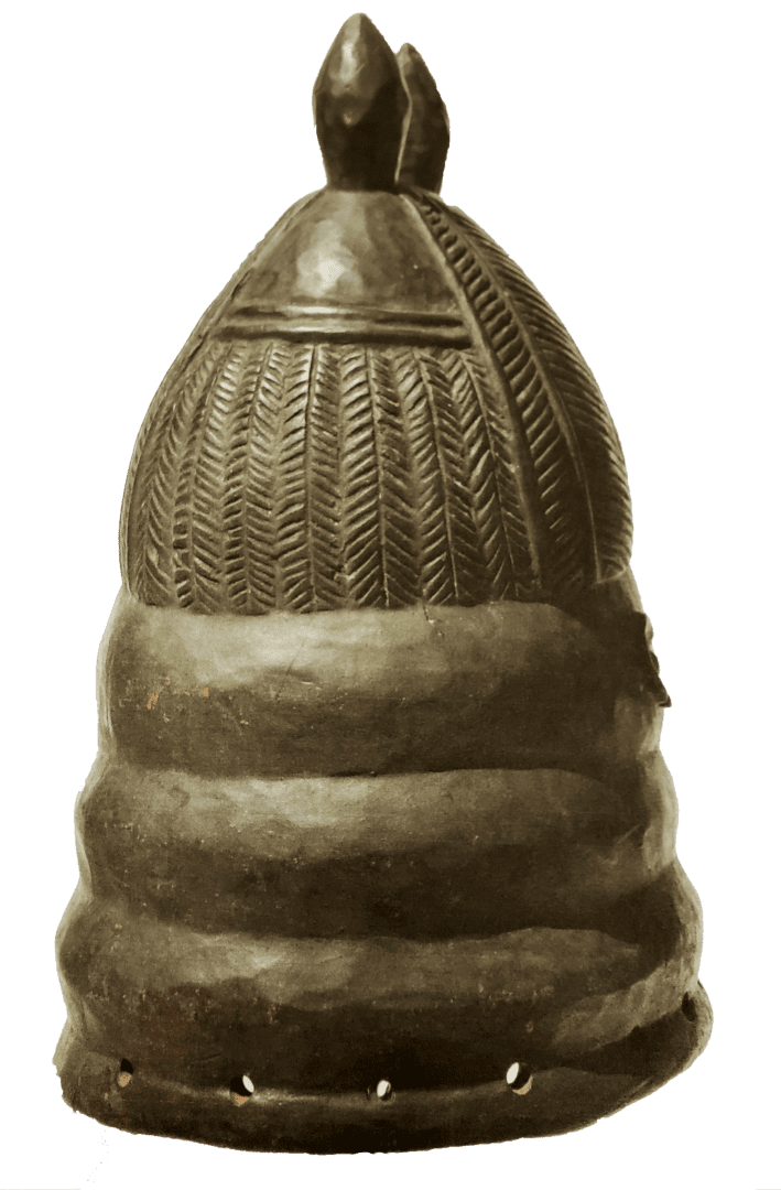 A tall, dark, dome-shaped ceremonial mask with a textured, herringbone-patterned upper section and ringed lower base.