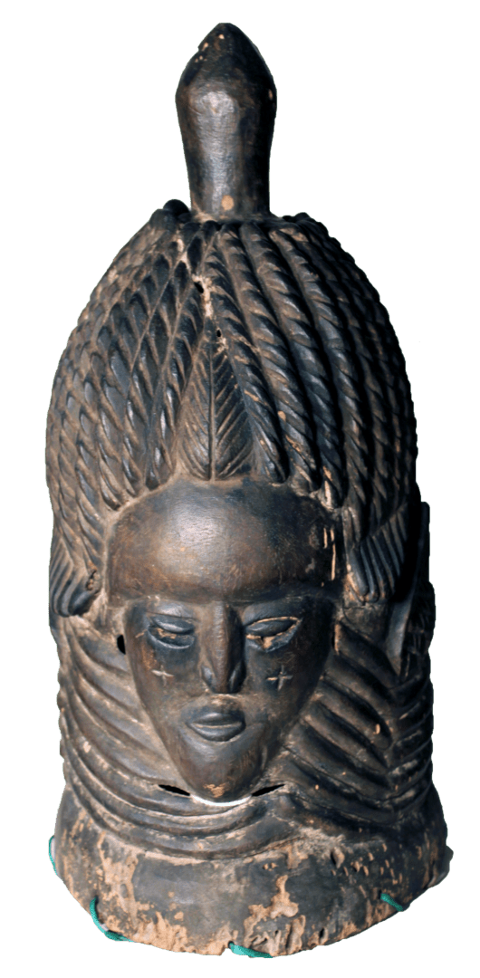 A dark-colored, carved wooden Sowei mask with an elaborate braided hairstyle and a prominent, pointed finial on top.