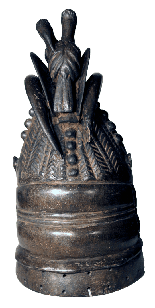 A dark, bell-shaped ceremonial object with an ornate, pointed crown featuring intricate feather-like patterns and beads.