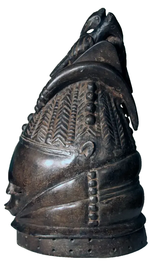 A dark, carved wooden helmet mask featuring intricate geometric patterns, bead-like rows, and a bird atop the crest.