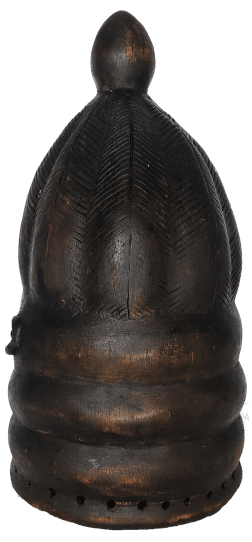 A carved, dark brown wooden headdress or finial with vertical ribbed patterns and a small knob at the top.