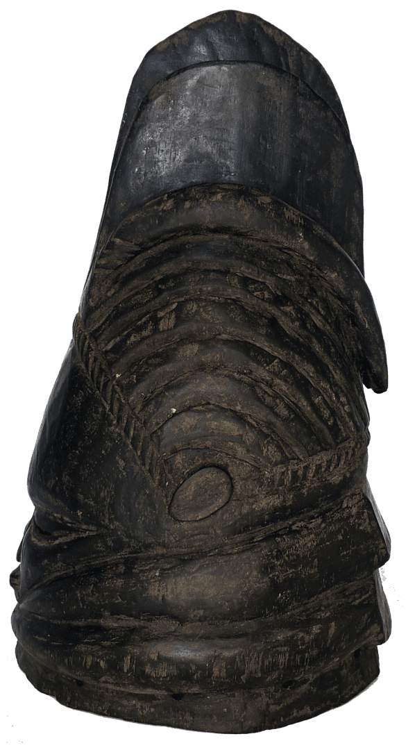 A dark, weathered leather shoe with a rounded toe and prominent, horizontal ridged detailing across the upper.
