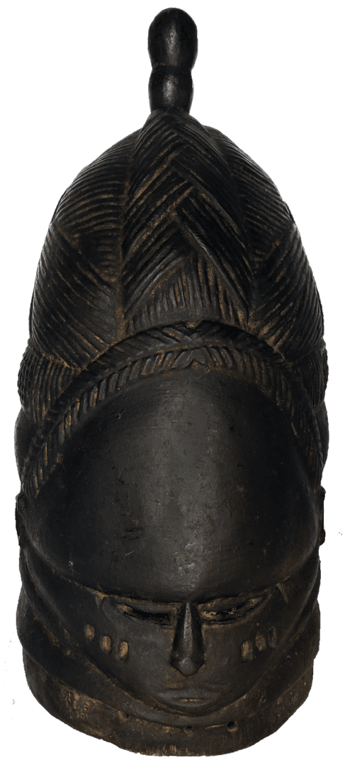 A dark, carved wooden helmet mask with a tall, textured hairstyle, stylized facial features, and a small knob on top.