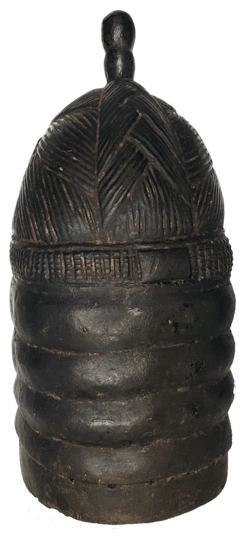 A dark, cylindrical wooden container with a ribbed body, a textured patterned lid, and a small, knob-like handle on top.