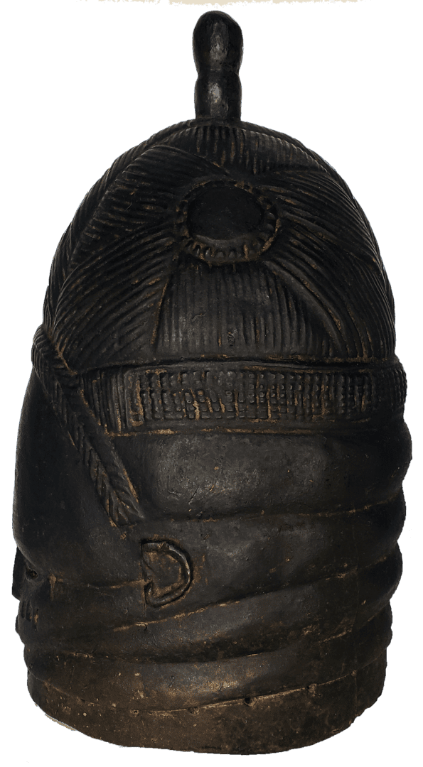 A dark-colored, cylindrical carved wooden object featuring a dome-shaped top with a small finial and ribbed textures.