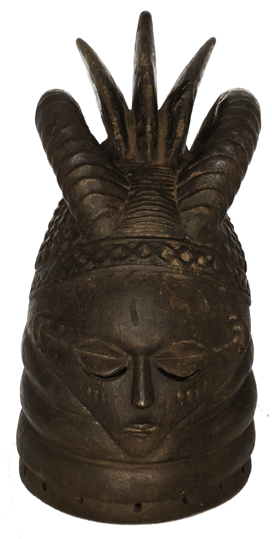 A dark wooden sculpture of a head with almond-shaped eyes, multiple horns, and intricate carved patterns.