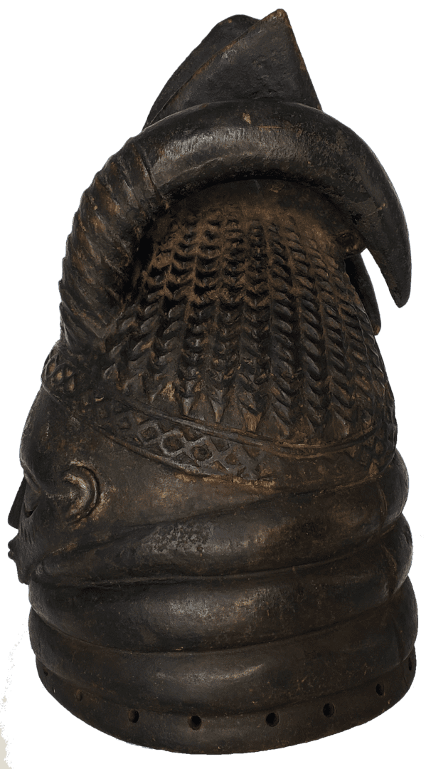 A dark brown, carved wooden artifact with a textured, lattice-like crown, layered base, and curved detail.