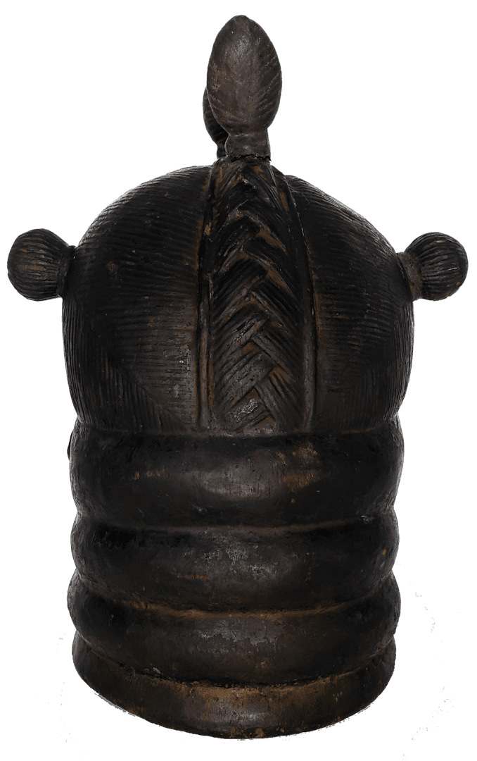 A dark, carved wooden vessel with a tiered base, textured dome lid featuring a vertical braid, and two side knobs.