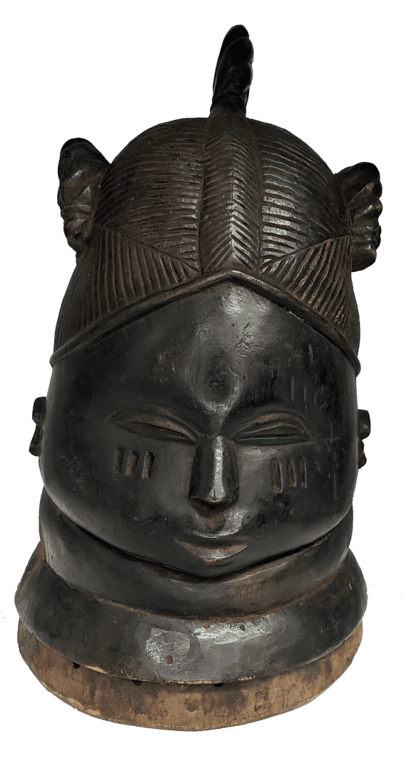 A dark-toned, carved wooden mask with an intricate hairstyle, stylized facial features, and three vertical cheek marks.