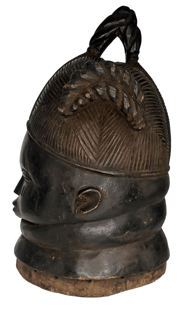 A dark-toned, carved wooden head sculpture with a textured, leaf-like hair design and a prominent circular neck roll.
