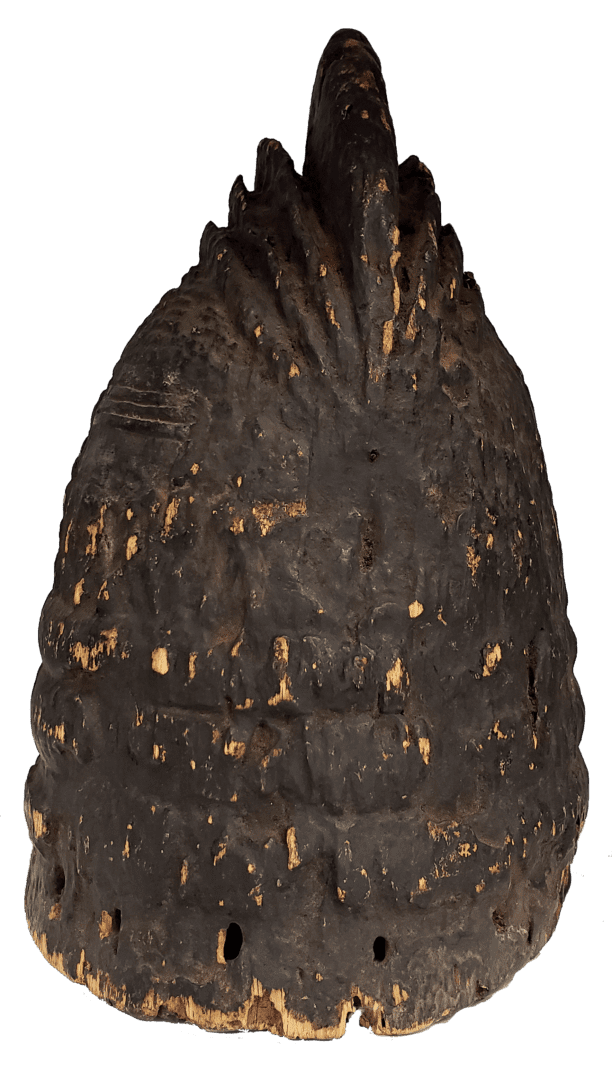 A conical, dark-brown wooden headdress with a spiked crest and small holes along the bottom rim.