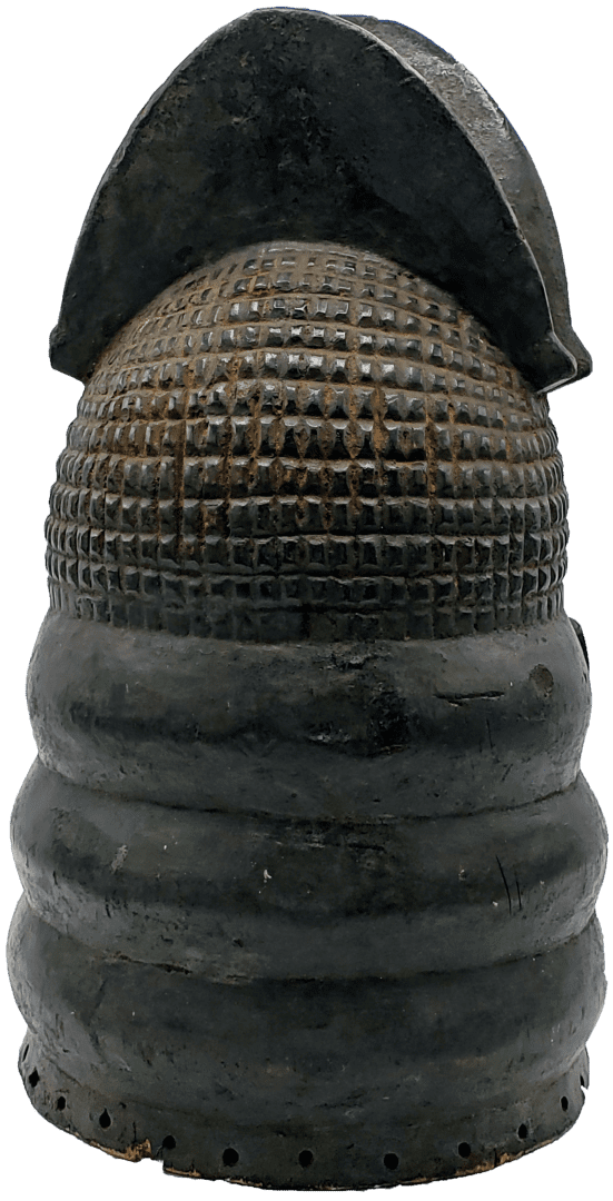 A dark, cylindrical clay object with a grid-patterned upper section and three horizontal ridges near the base.
