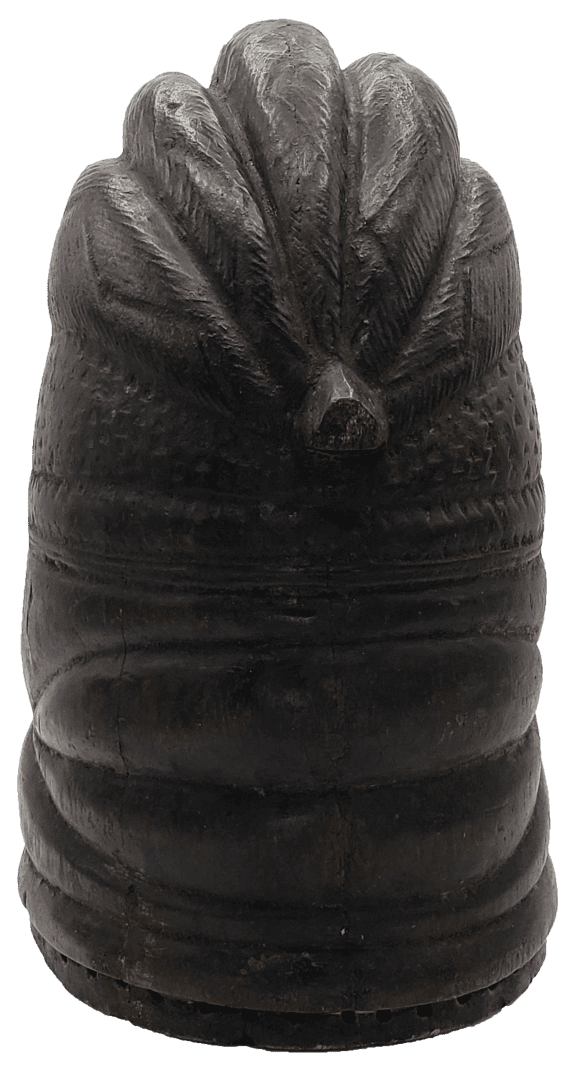 A dark, carved wooden finial featuring a stylized, fan-like motif at the top and horizontal ridges along its base.