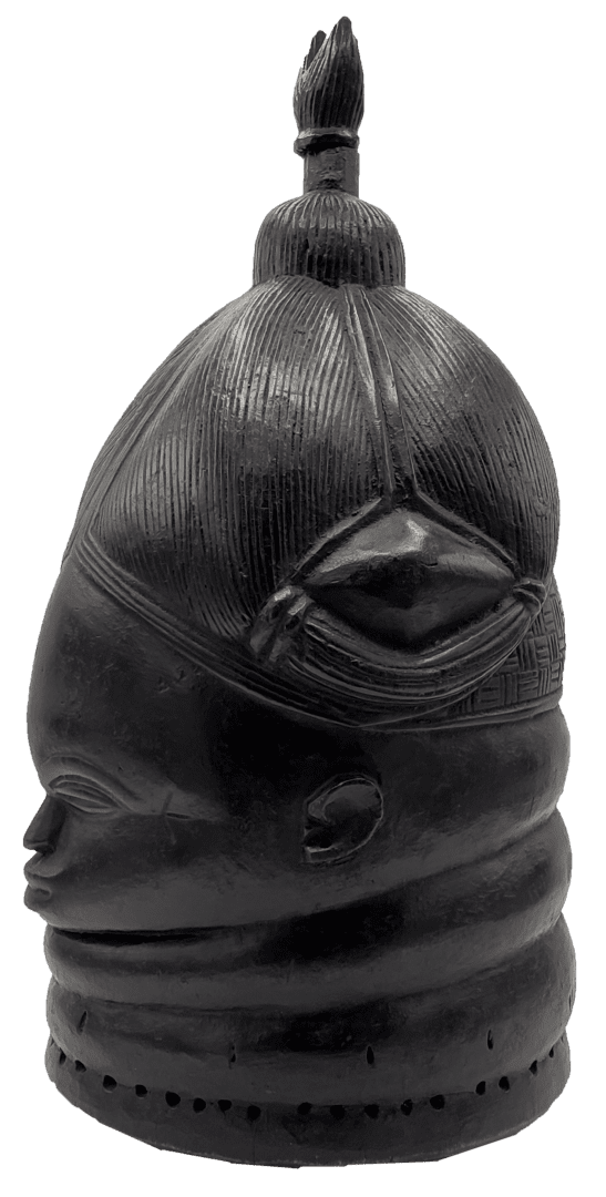 A carved, black wooden helmet mask with a tall, rounded head, ringed neck, and a small finial ornament on top.