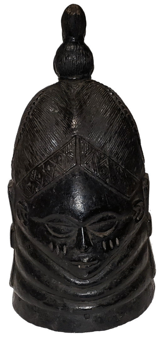A dark, carved wooden helmet mask featuring an elaborate tiered hairstyle, facial scarification, and neck ring details.