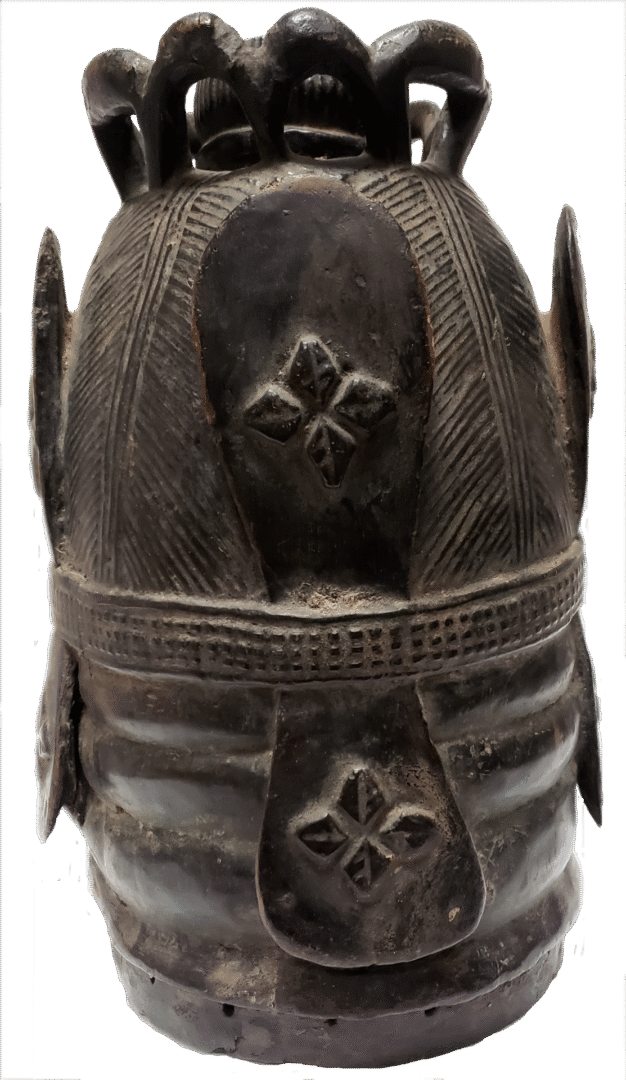 A dark, cylindrical wooden drum with a carved base, ribbed sides, and a decorative, flared, open-work top.