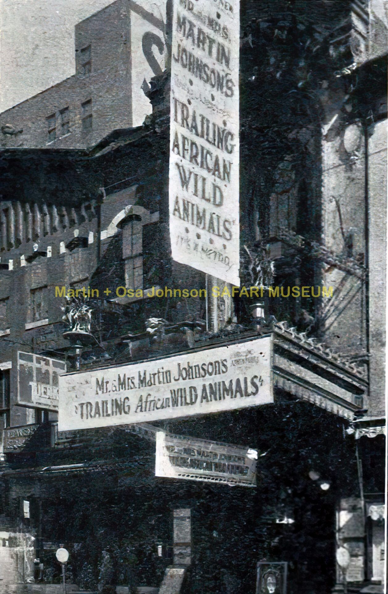 Movie theater entrance displaying signs for