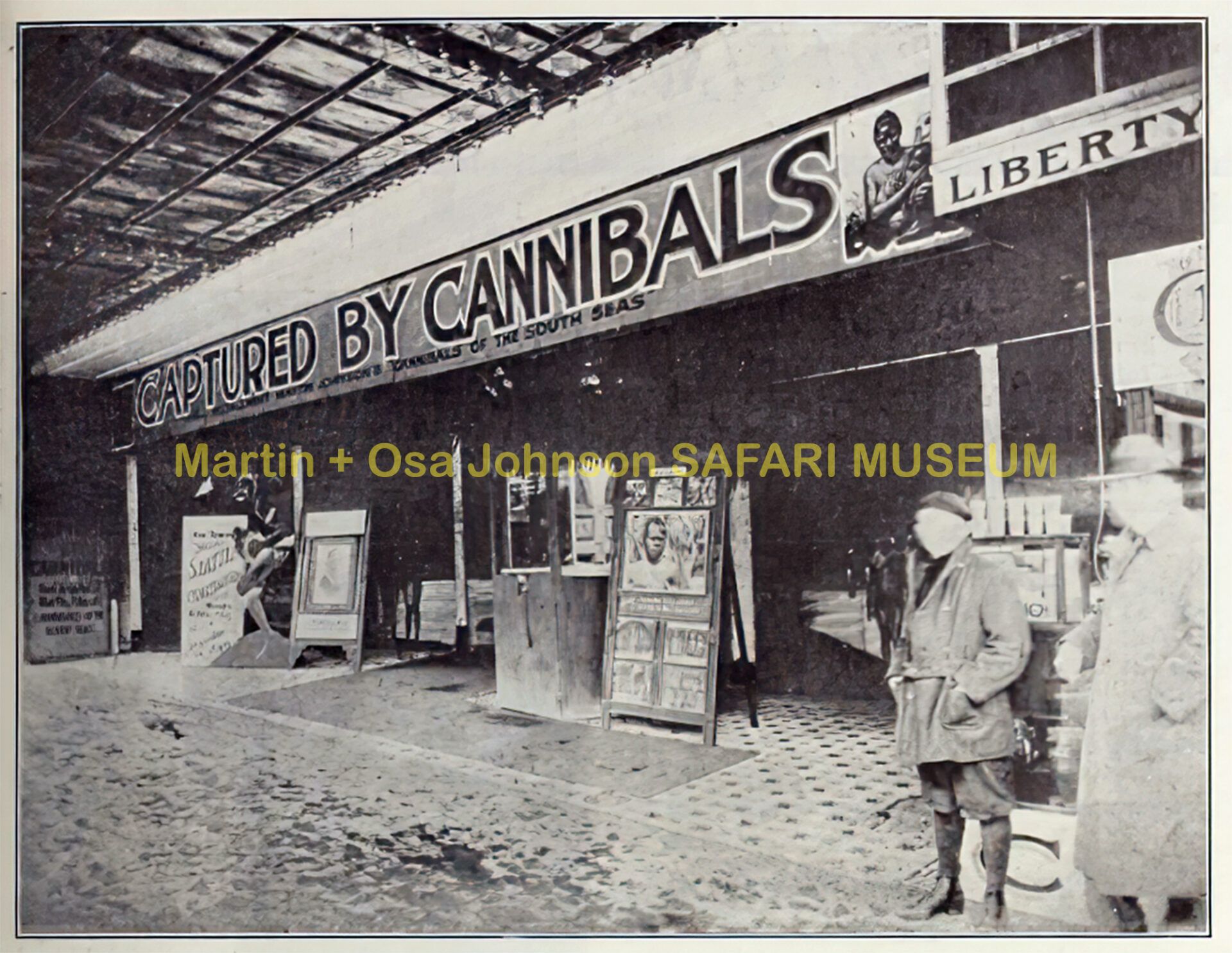 Black and white photo of a movie theater facade with a banner reading