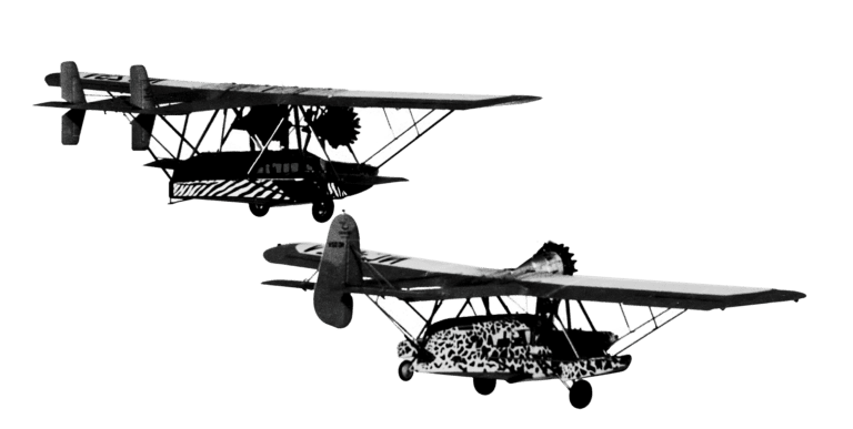 Two vintage, high-wing monoplanes flying in formation against a plain white background.