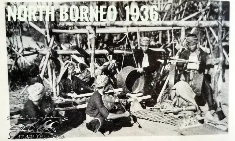 A black-and-white 1936 photo showing people playing traditional gongs and percussion instruments in North Borneo.