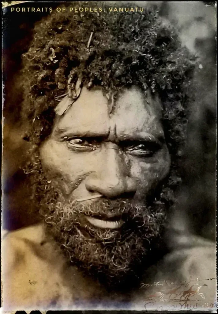 A portrait of an indigenous person from Vanuatu with textured dark hair and a beard, looking directly at the camera.