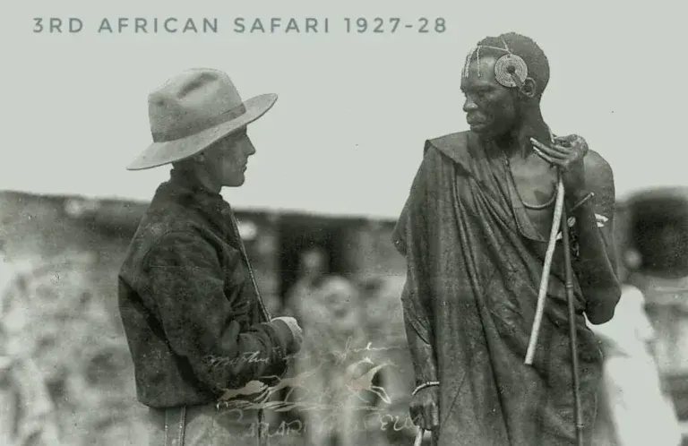 A person in a hat and a person in traditional cloth holding a staff stand facing each other, labeled 