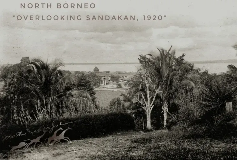 Black and white 1920 historical photograph of Sandakan, North Borneo, showing a tropical landscape overlooking the bay.