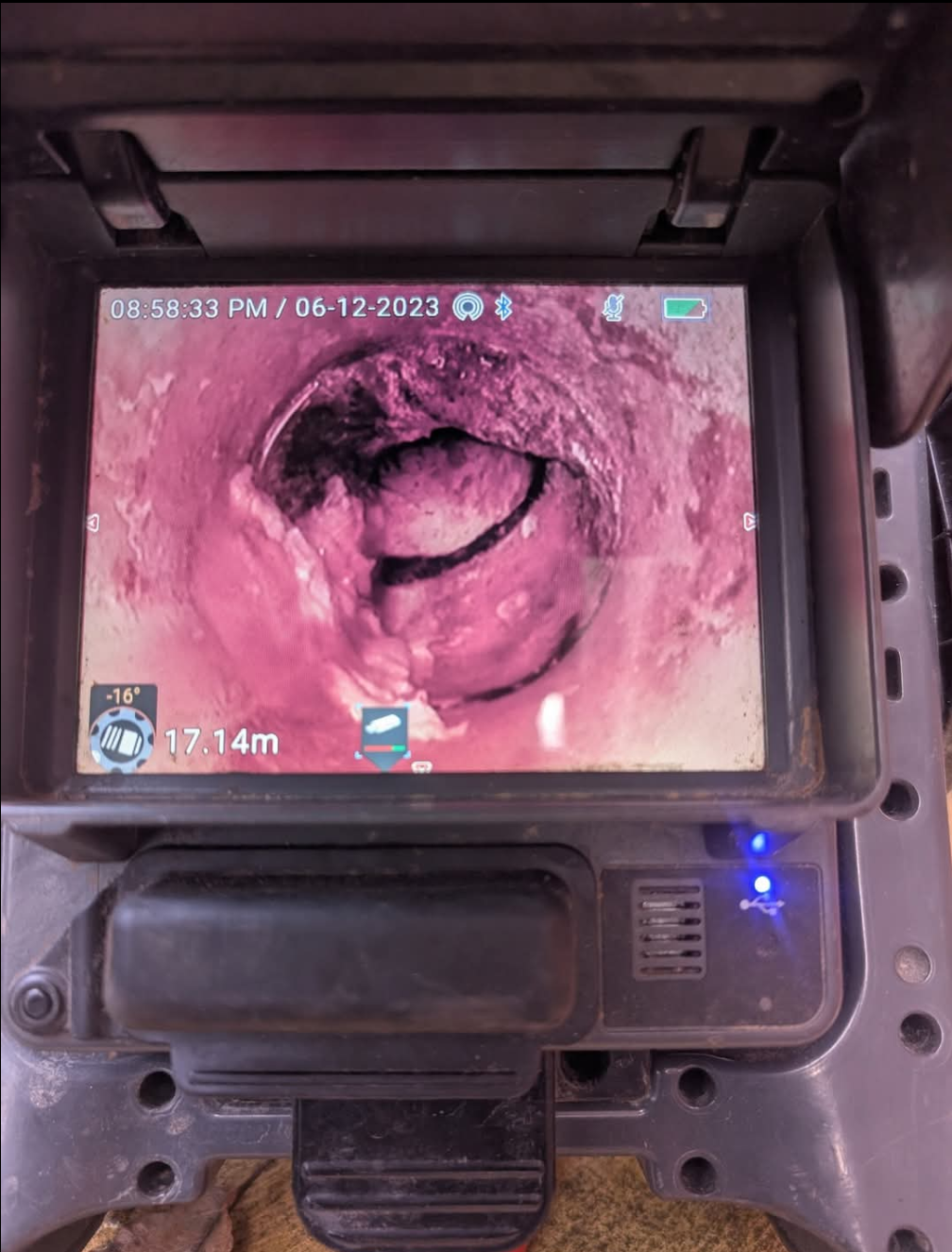 Endoscopic view of a pink intestinal tunnel with a dark obstruction or lesion inside — TasWide Plumbing in Kingston, TAS