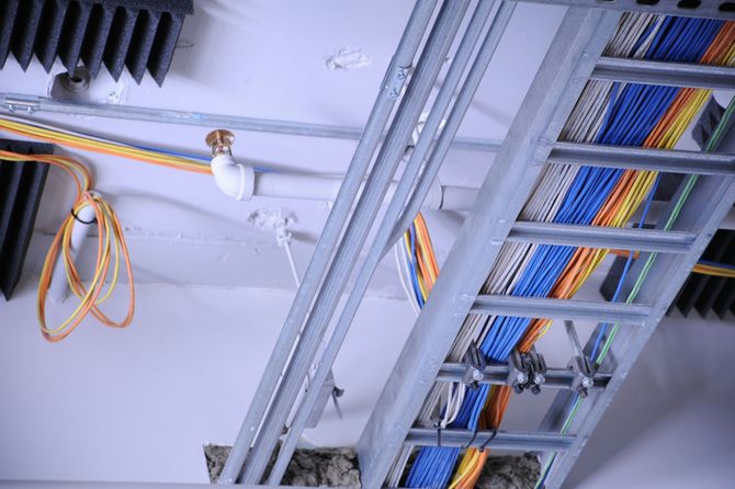Cable trays with multicolored network cables in a ceiling installation