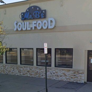 Exterior of Mr. B’s Soul Food restaurant with beige facade and large white sign above windows