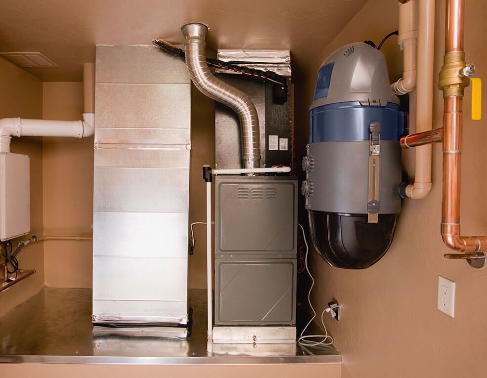 A room with a stove and pipes in it
