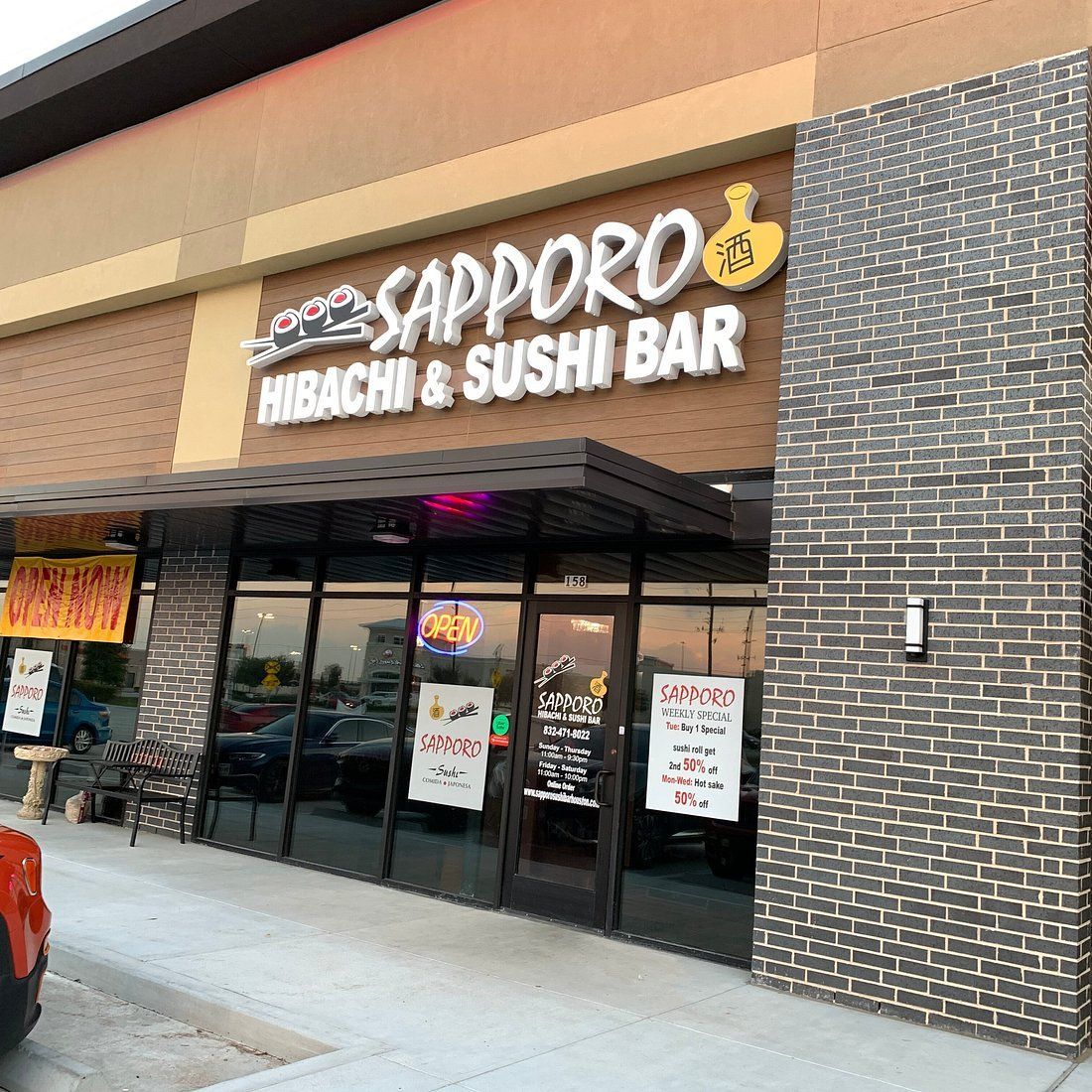 Storefront of Sapporo Hibachi & Sushi Bar with glass doors and brick facade in a shopping center