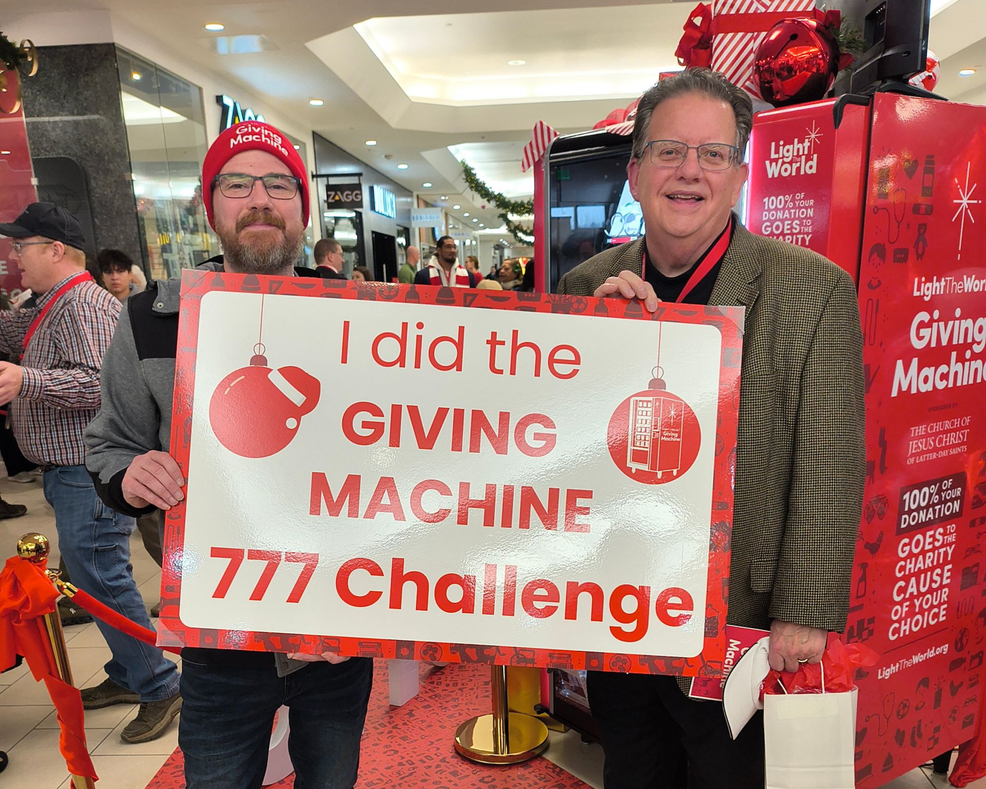 Two men hold a sign for