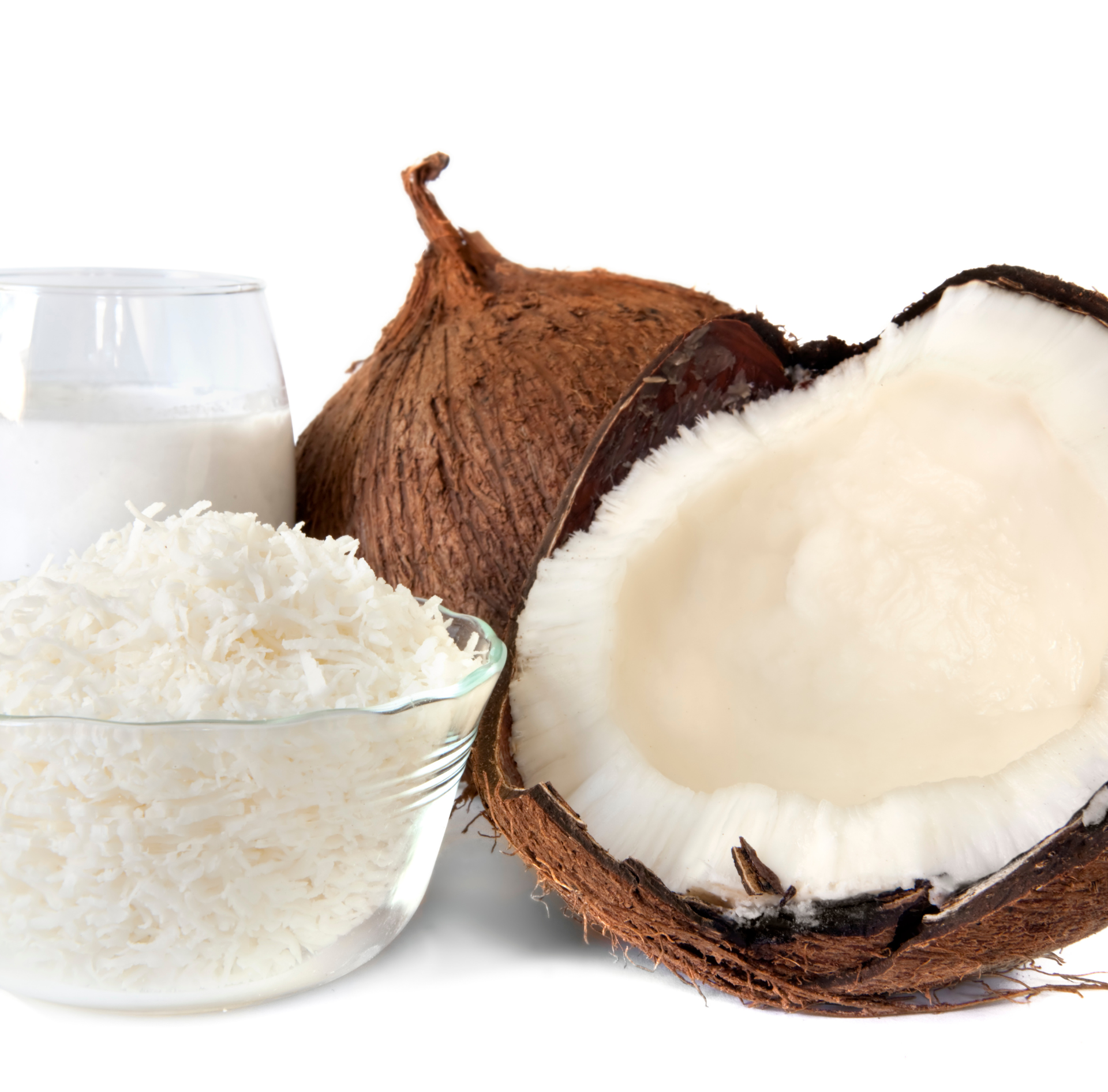 Coconut, shredded coconut in a glass bowl, coconut milk, and halved coconut on white background
