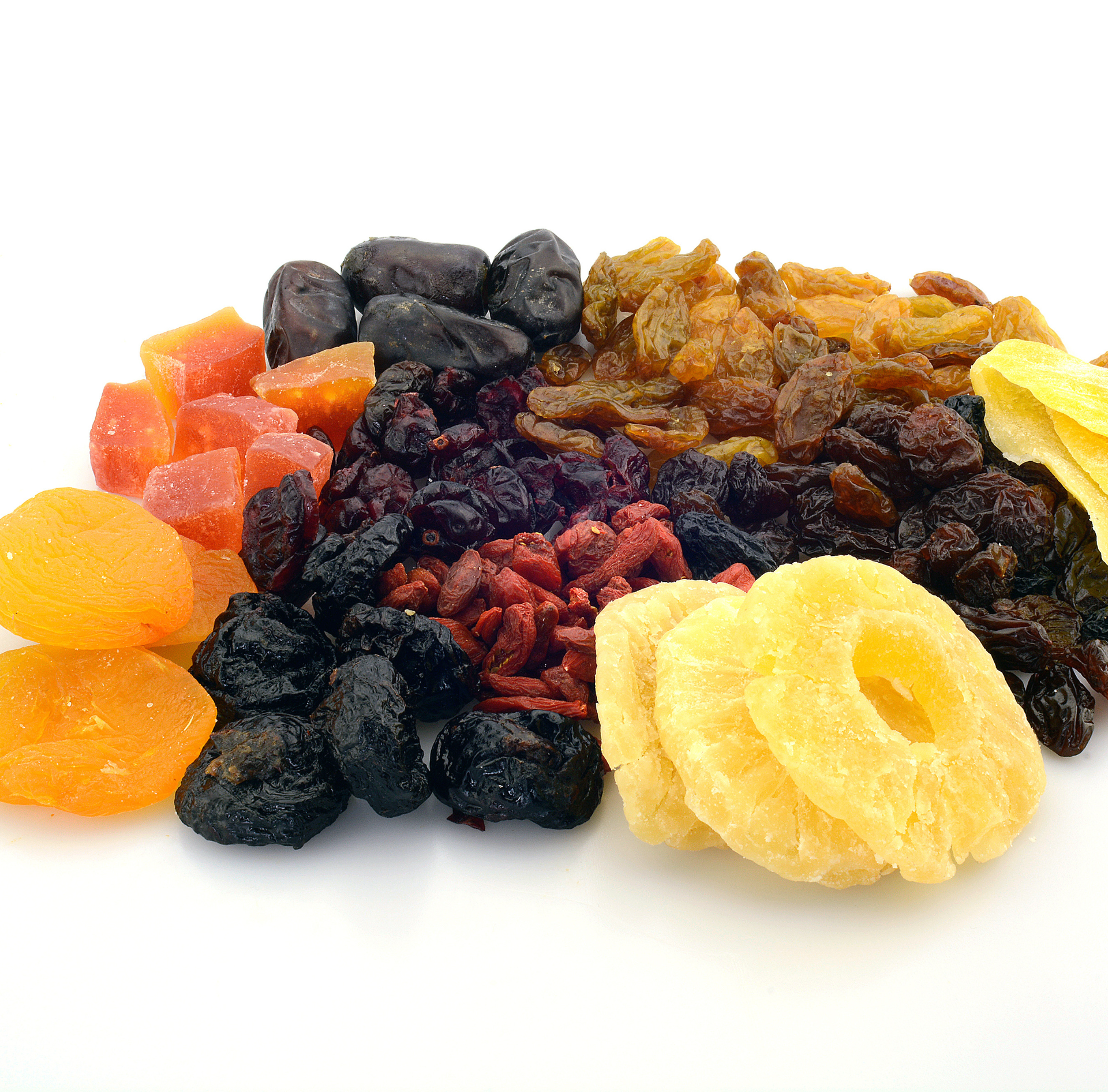 Assorted dried fruits and nuts on a white background