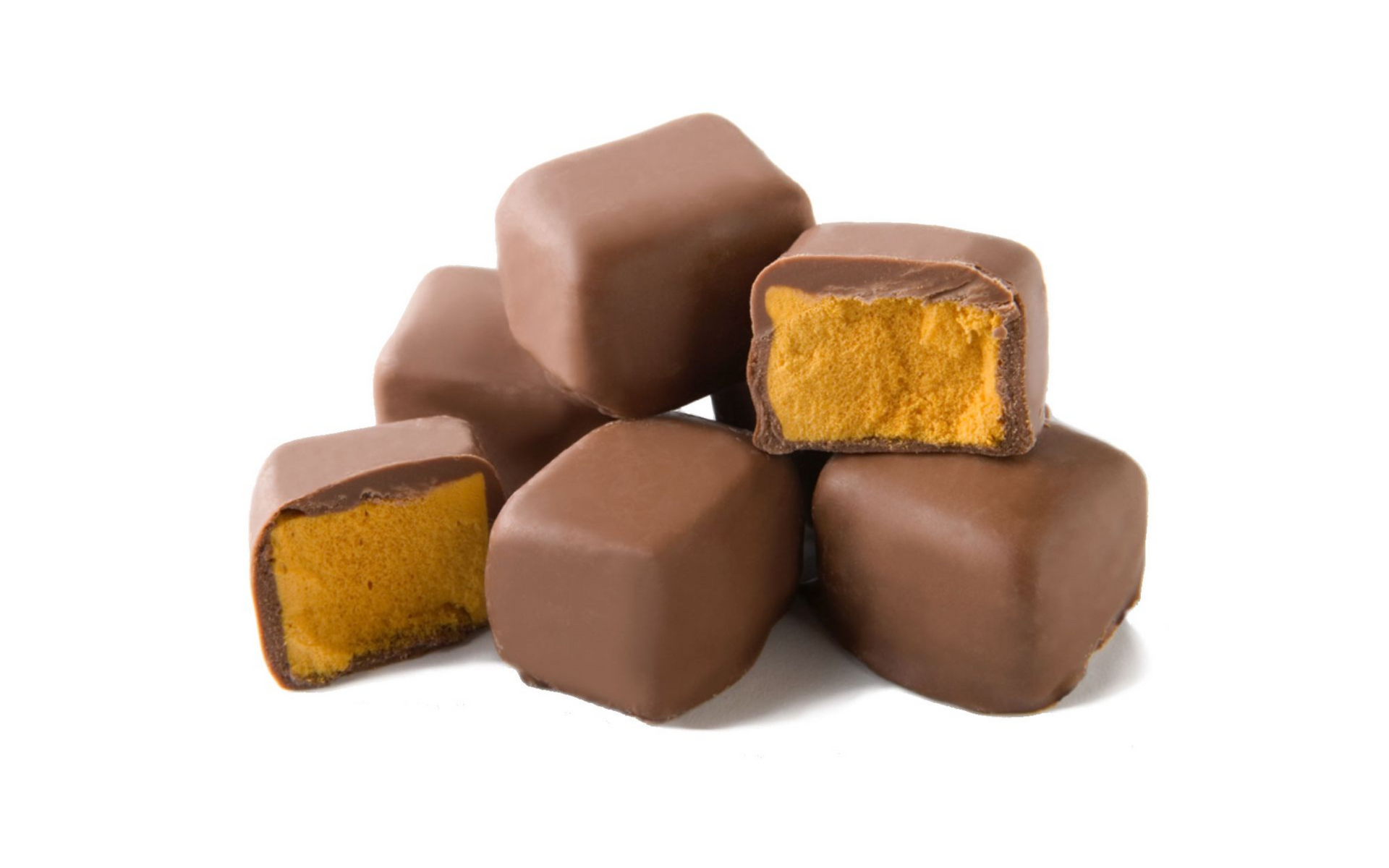 Chocolate truffles with a golden filling, arranged in a small stack on a white background