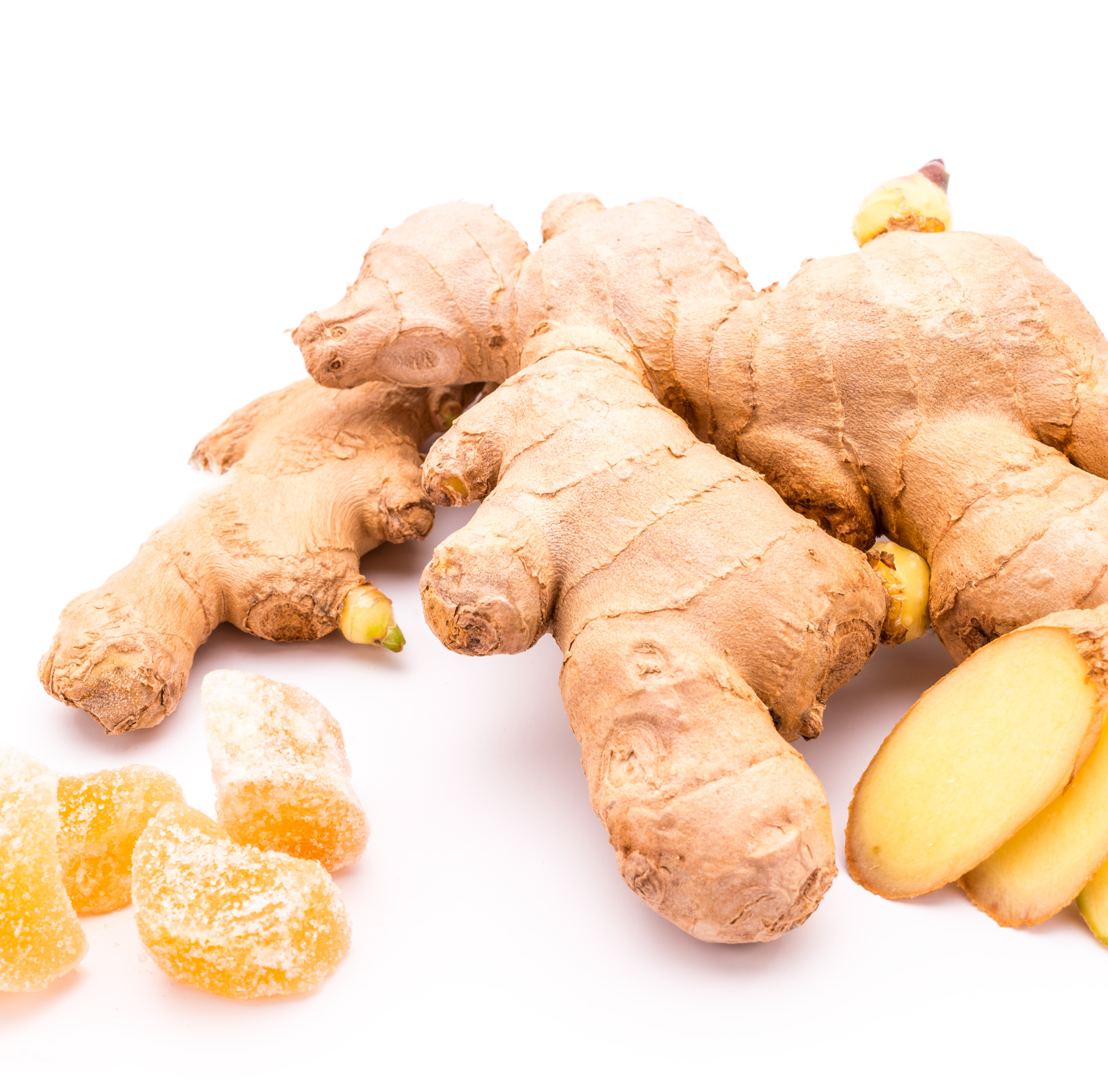 Fresh ginger roots with sliced pieces on a white background