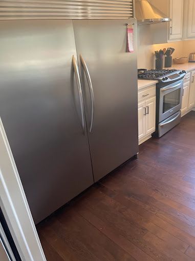 a kitchen with a large stainless steel refrigerator and stove .