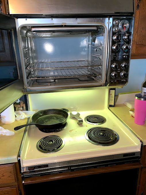 a frying pan is sitting on top of a stove in a kitchen .