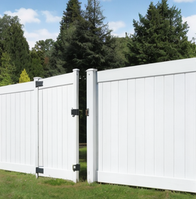 a white fence with a gate that is open