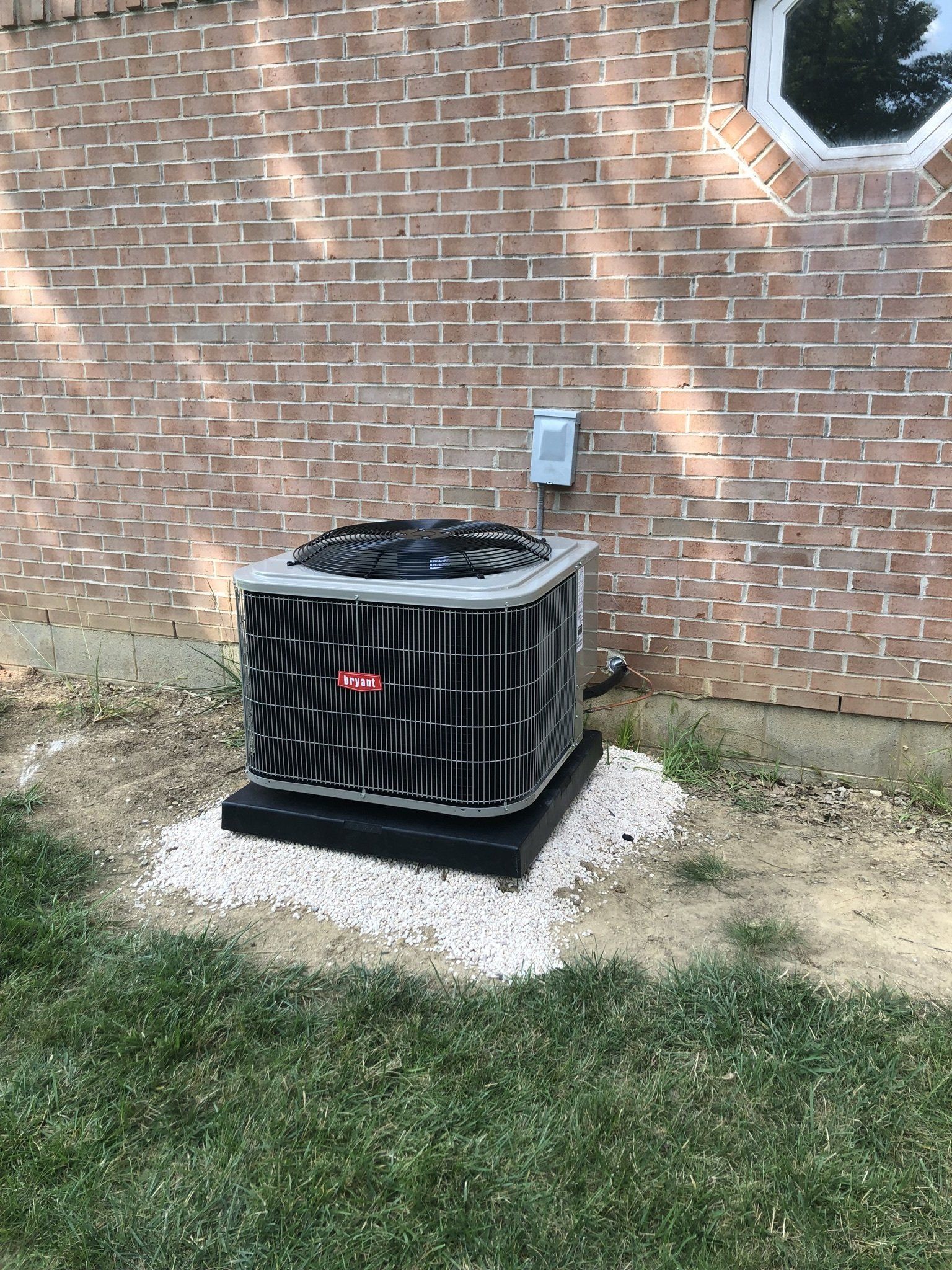 Heat Pump Installed on a Bricked Wall — Spencerville, OH — Matt’s Heating & Cooling LLC