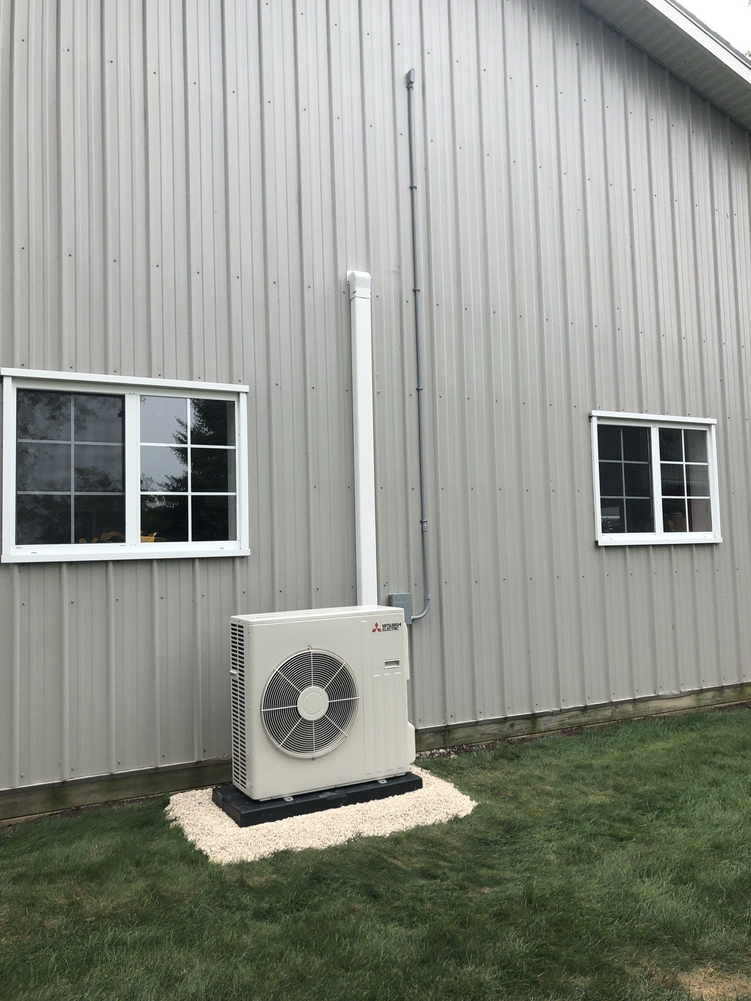 White Inverter Installed Near the Window — Spencerville, OH — Matt’s Heating & Cooling LLC