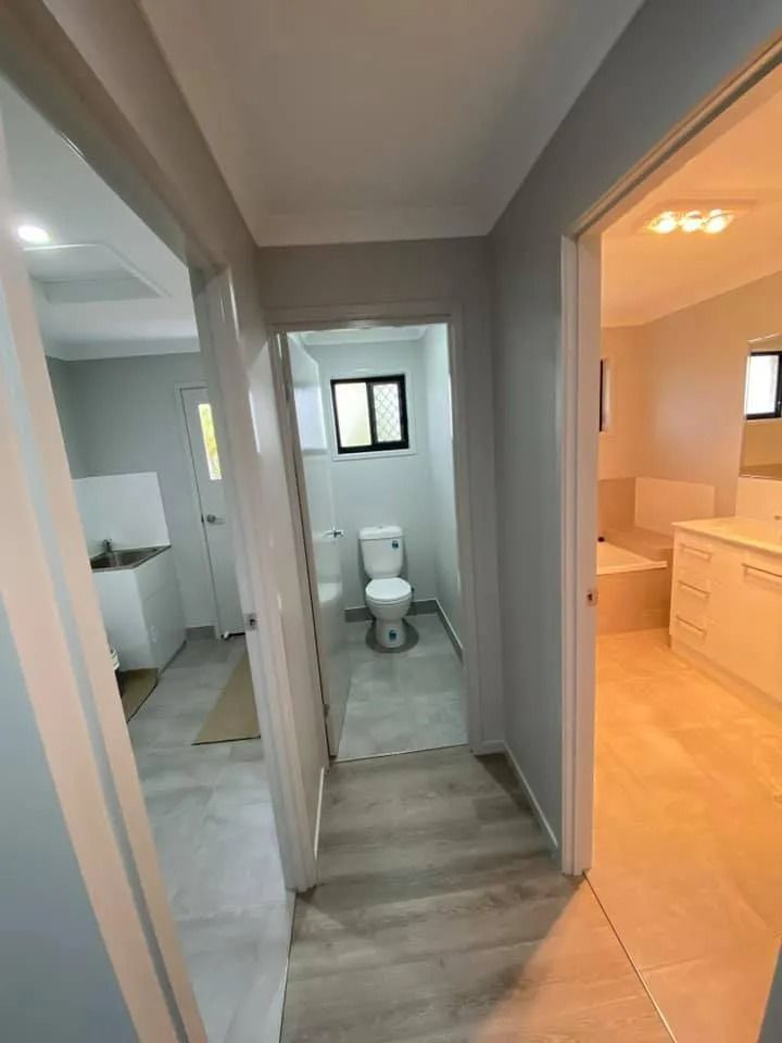 Narrow Hallway with Doorways Leading to A Bathroom, Laundry — Country to Coast Homes In Gregory River, QLD